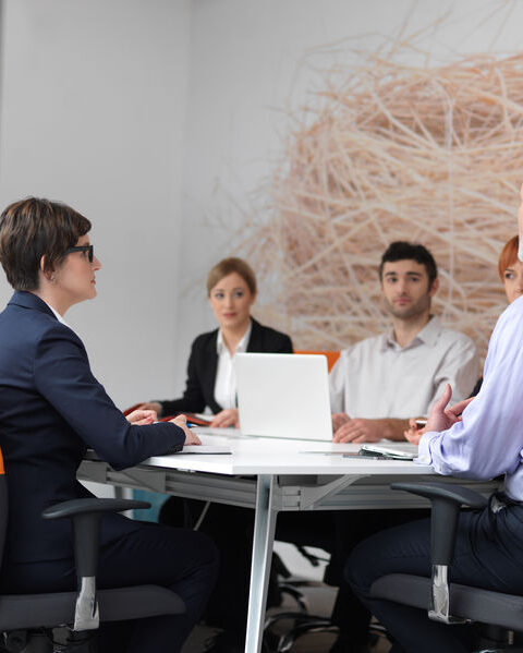 Private Investigator Vancouver Business and Corporate Cases as a group of employee are seated in a meeting room to present the workplace misconduct investigation findings.