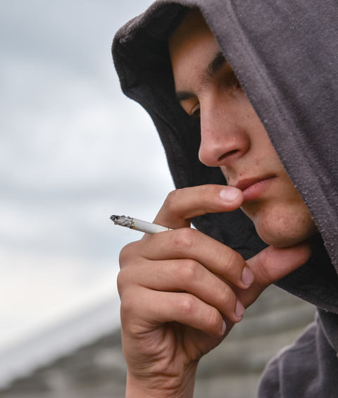 Private Investigator Vancouver Wellness Check Case as a teenager smokes a cigarette while in heavy contemplation.